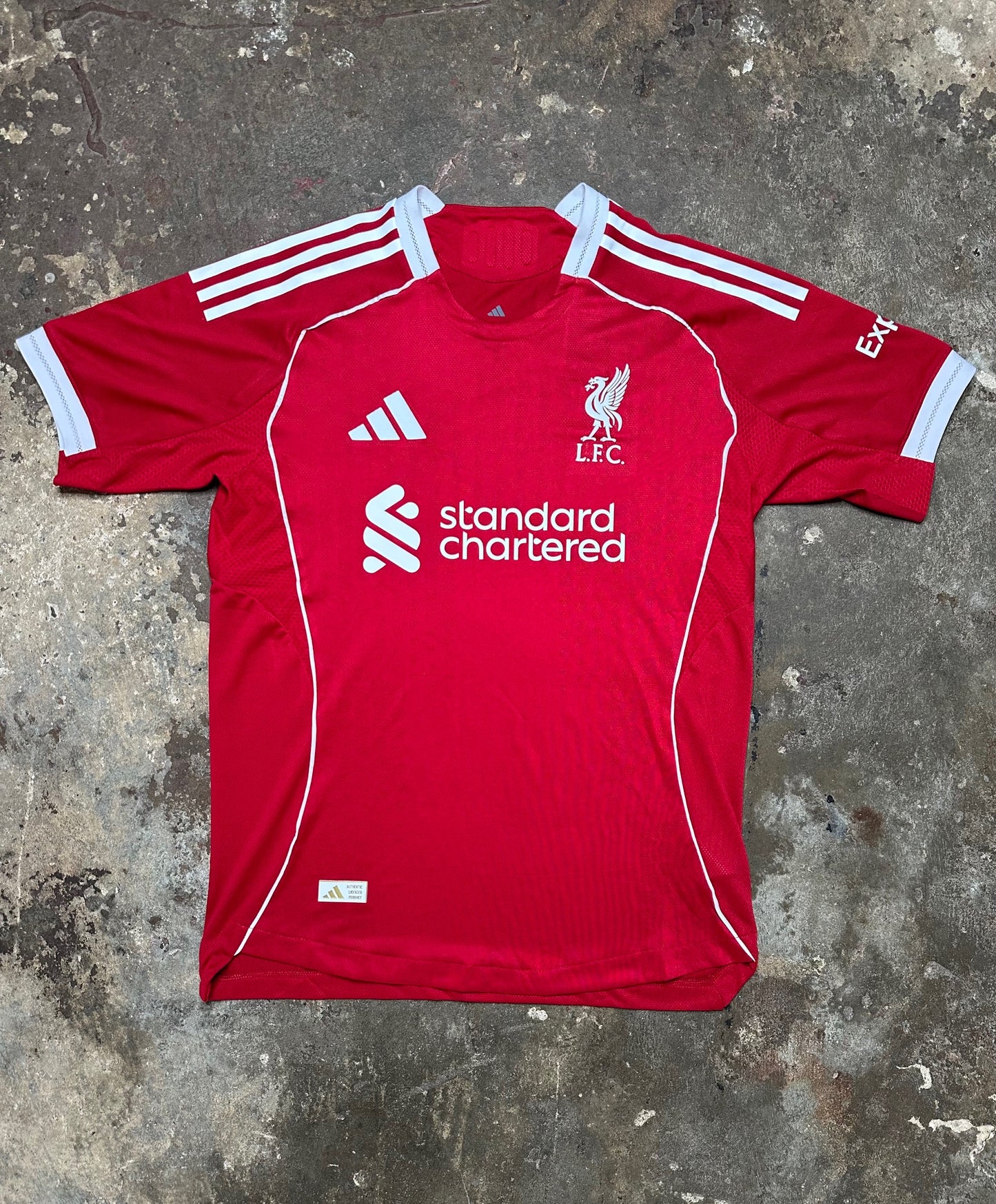 Liverpool 25/26 Home Player Version Jersey – Red – L.F.C. Crest – Standard Chartered Sponsor – 3-Stripes Shoulders