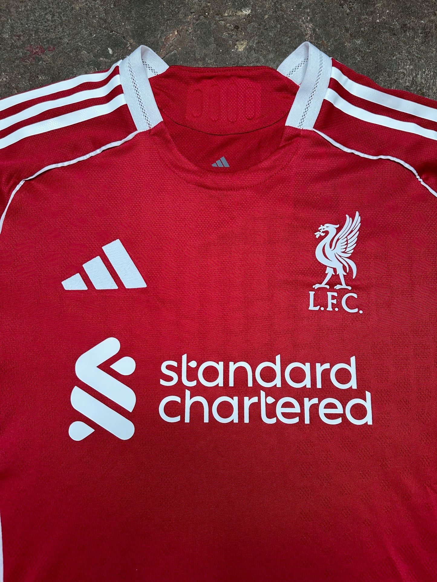 Liverpool 25/26 Home Player Version Jersey – Red – L.F.C. Crest – Standard Chartered Sponsor – 3-Stripes Shoulders