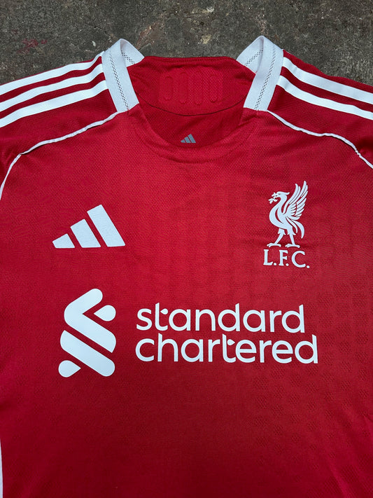 Liverpool 25/26 Home Player Version Jersey – Red – L.F.C. Crest – Standard Chartered Sponsor – 3-Stripes Shoulders